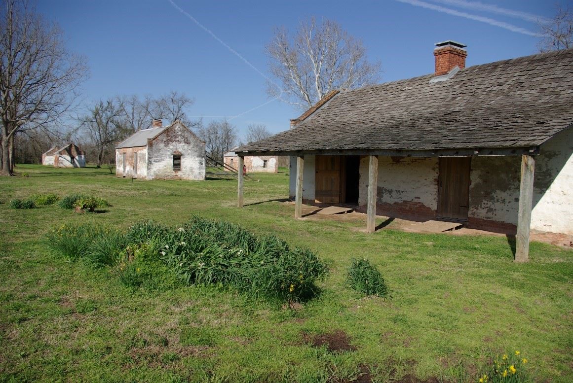 Double row of former slave/tenant farmer houses with remnant gardens at Magnolia Plantation, Cane River Creole National Historical Park, Derry, Louisiana.